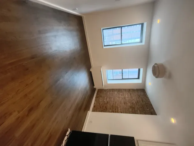 a view of room with wooden floor