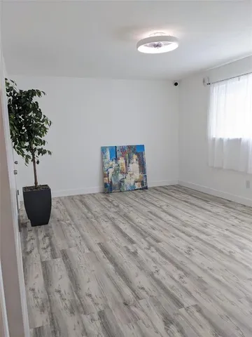 a bedroom with a bed and a potted plant