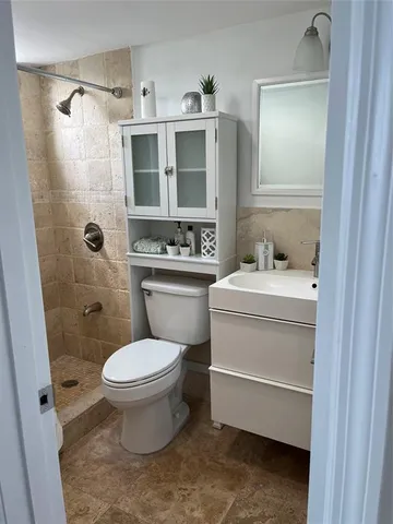 a bathroom with a sink toilet and shower