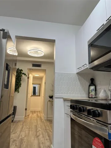 a view of a kitchen with a sink and a stove