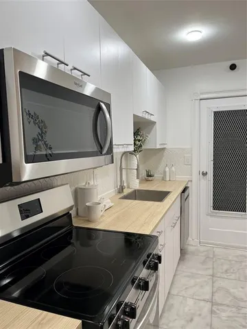 a kitchen with a sink and stove