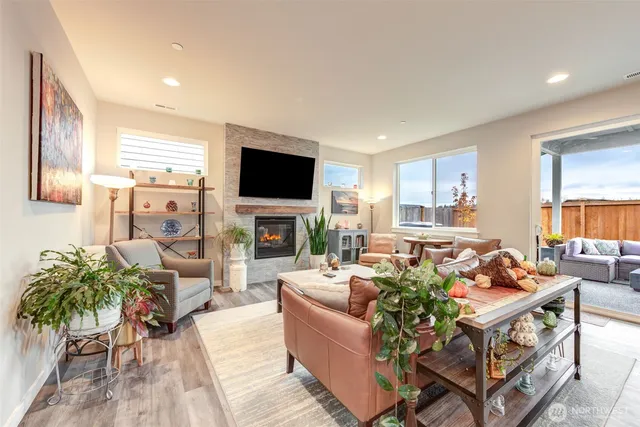 a living room with furniture a flat screen tv and a fireplace