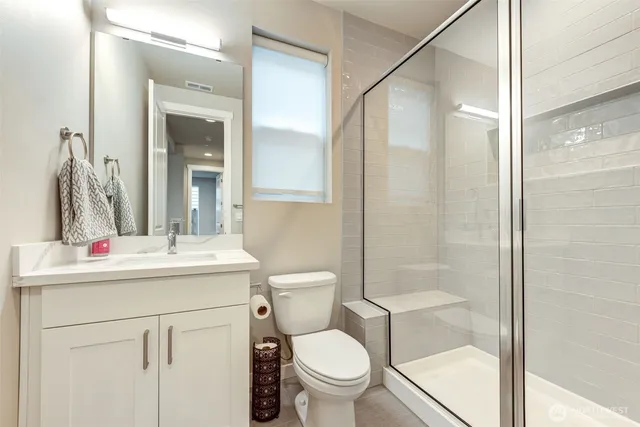 a bathroom with a sink toilet and shower