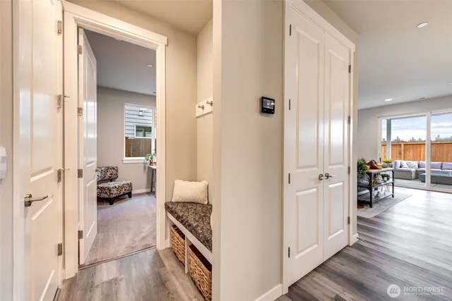a en suite bathroom with a tub shower and hardwood floor