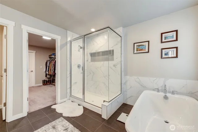 a bathroom with a tub shower and sink