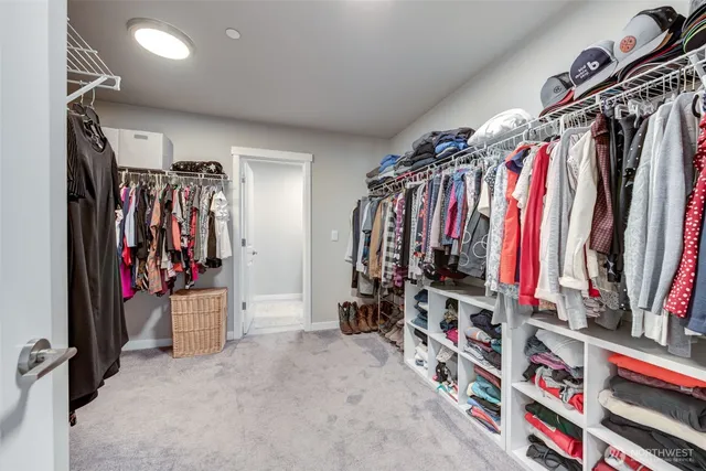 a view of walk in closet with clothes