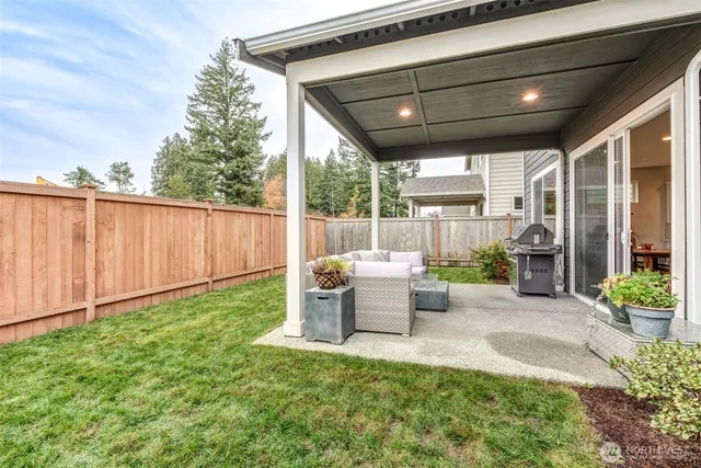 a view of a patio with table and chairs potted plants with wooden fence