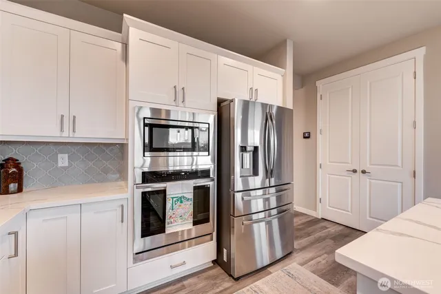 a kitchen with stainless steel appliances a refrigerator and cabinets
