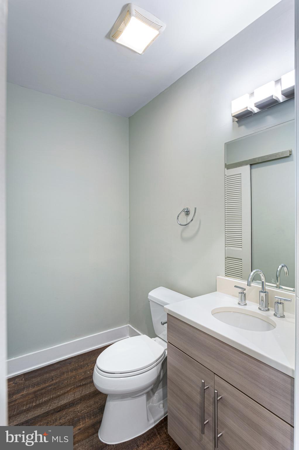 1219 K Street Northeast, Unit 203 Washington, DC 20002 - Photo 4 of 10 a bathroom with a sink a toilet and a mirror