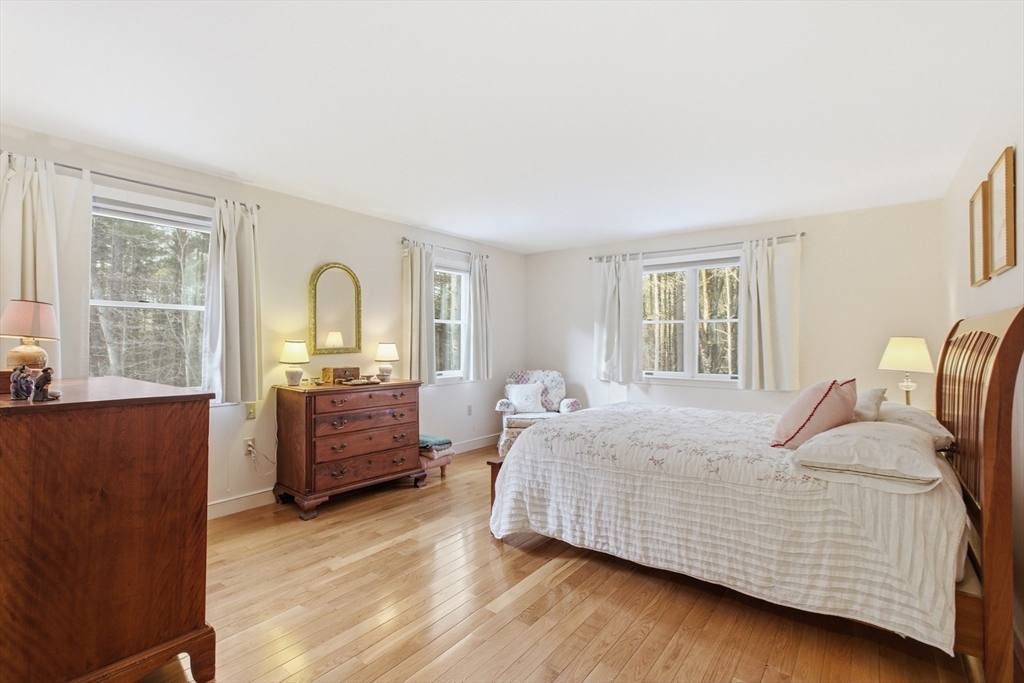 18 Quail Run, Unit 18 Acton, MA 01720 - Photo 12 of 23 a bedroom with a bed and wooden floor