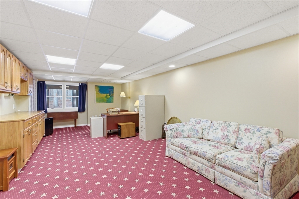 18 Quail Run, Unit 18 Acton, MA 01720 - Photo 14 of 23 a living room with furniture and a table