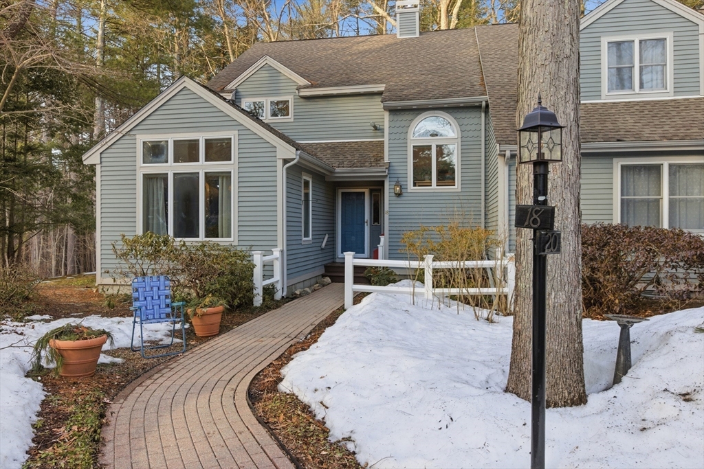 18 Quail Run, Unit 18 Acton, MA 01720 - Photo 3 of 23 a view of a brick house with many windows next to a yard