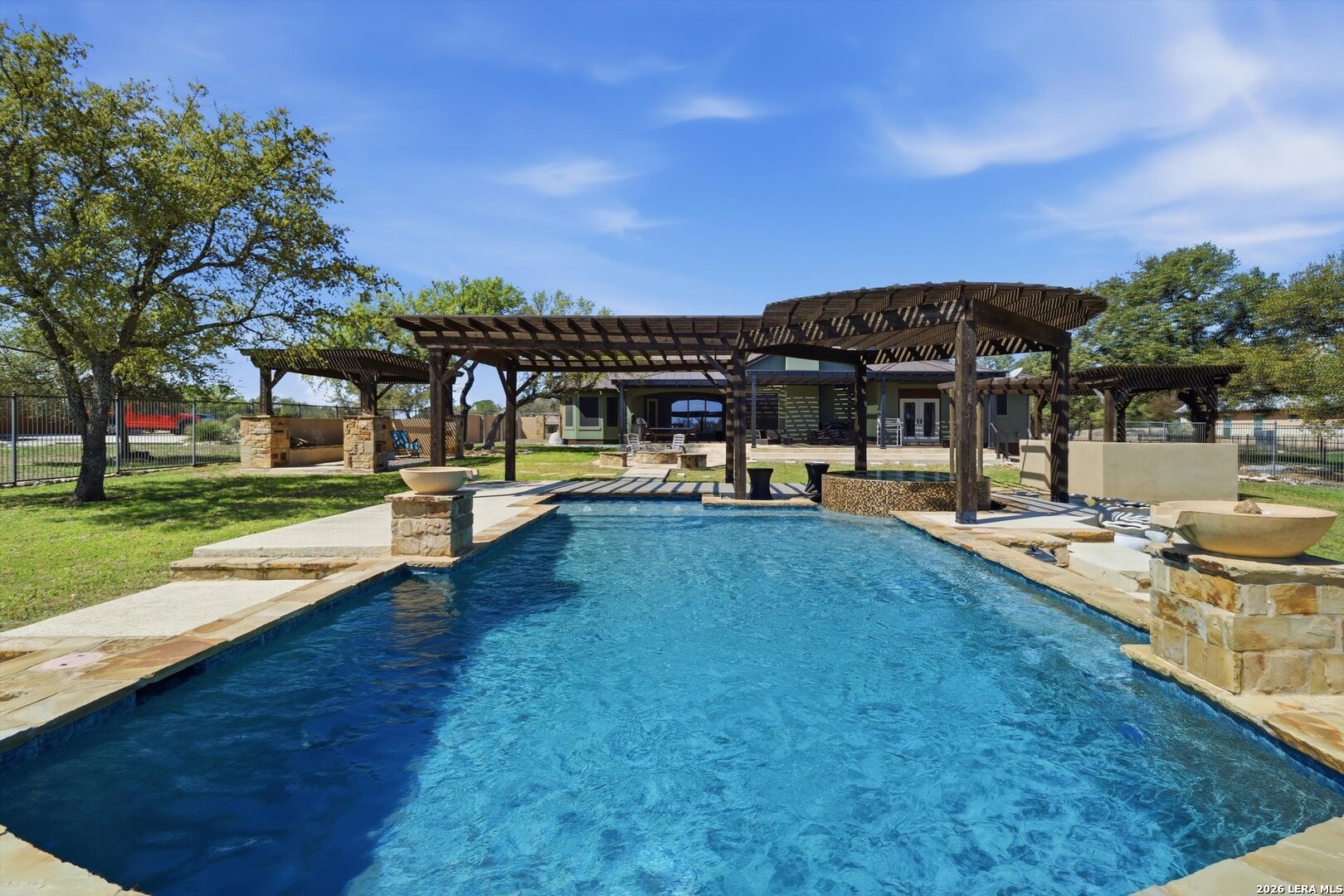 a view of a house with swimming pool and sitting area