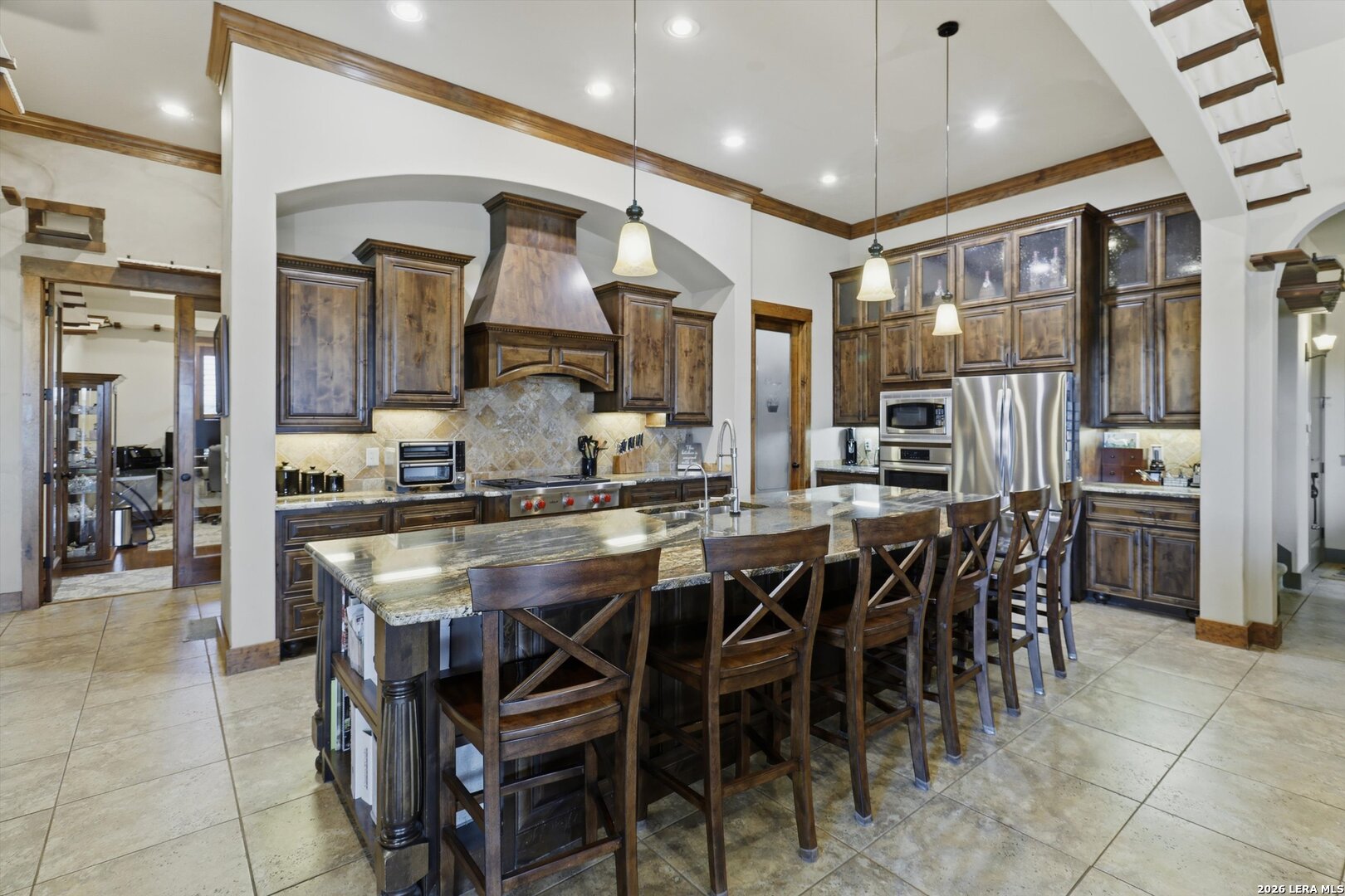 439 Mystic Parkway Spring Branch, TX 78070 - Photo 13 of 39 a kitchen with stainless steel appliances kitchen island granite countertop a table chairs and a refrigerator