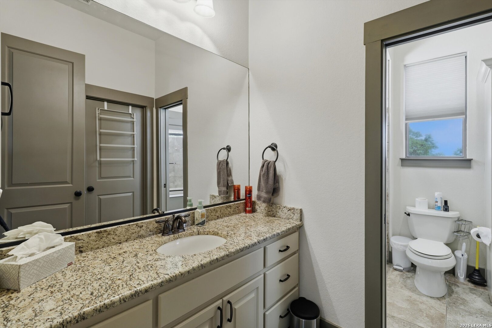 439 Mystic Parkway Spring Branch, TX 78070 - Photo 15 of 39 a bathroom with a granite countertop sink toilet and mirror