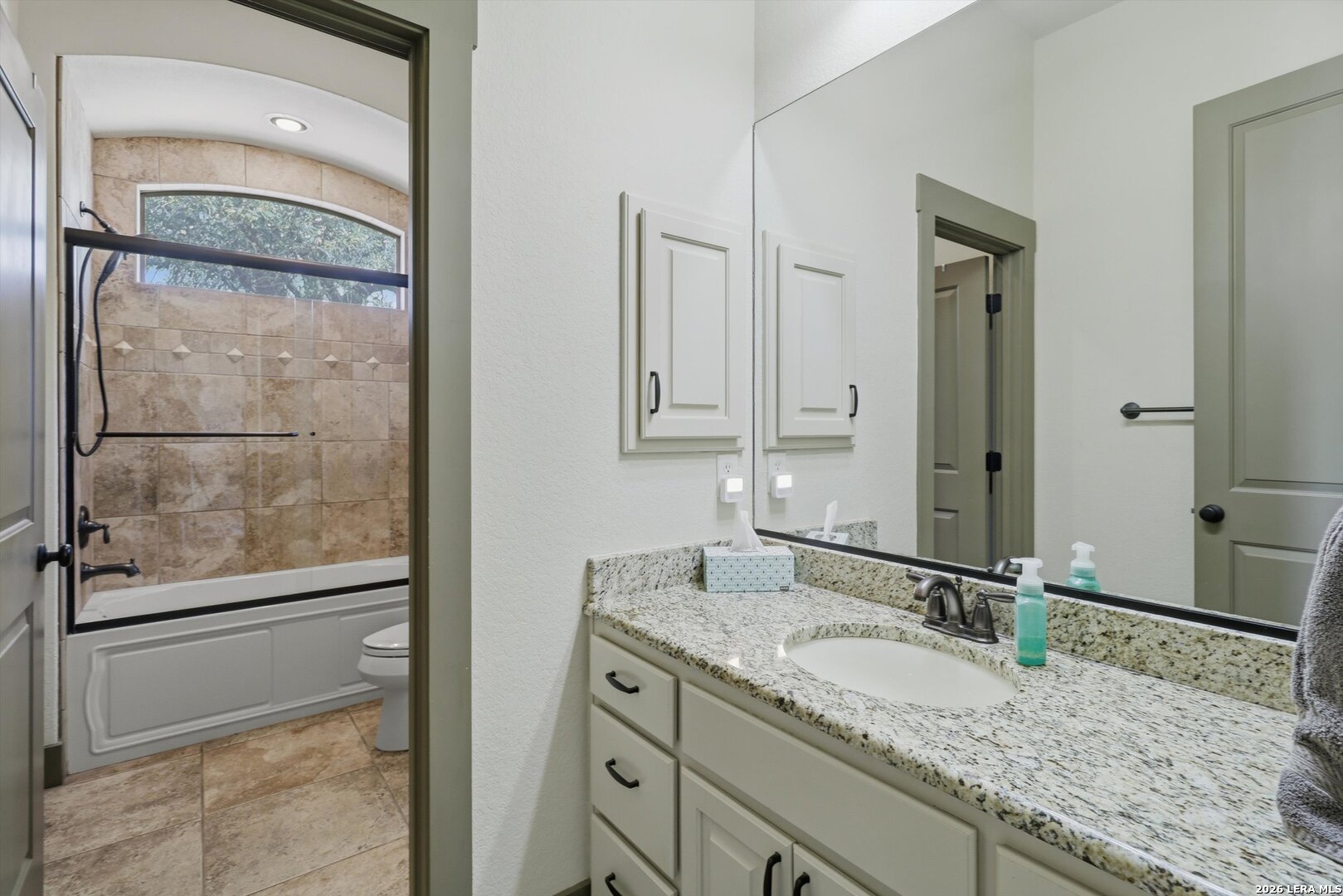 439 Mystic Parkway Spring Branch, TX 78070 - Photo 18 of 39 a bathroom with a granite countertop sink and a mirror