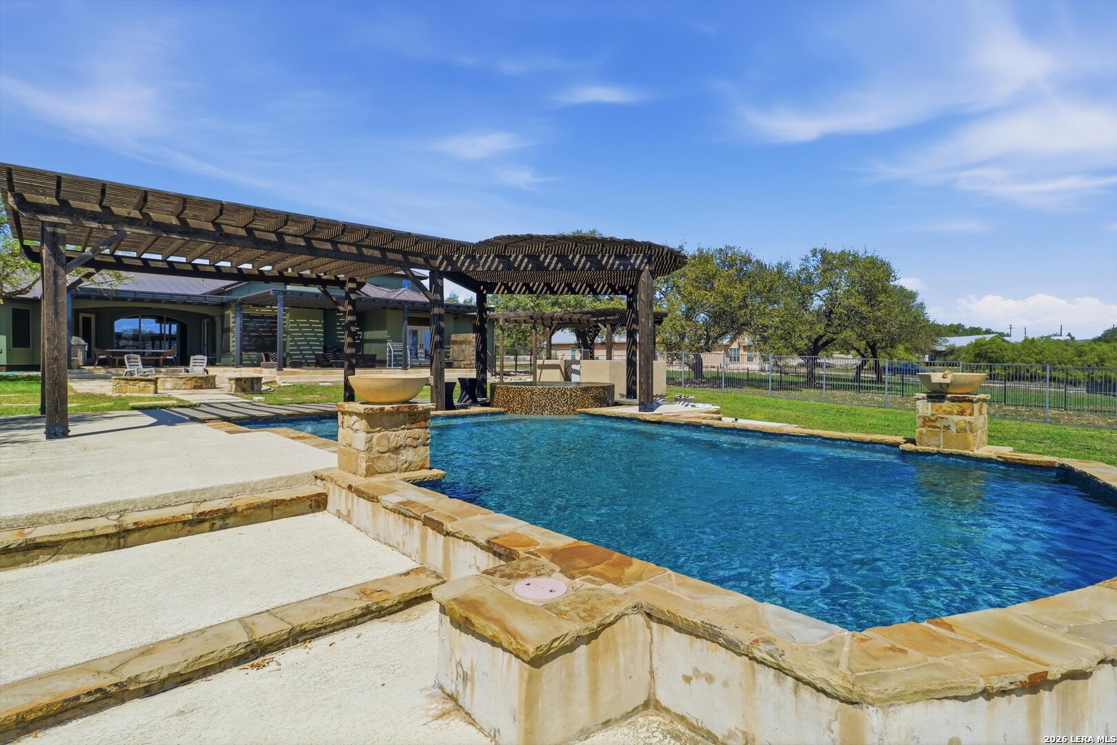 439 Mystic Parkway Spring Branch, TX 78070 - Photo 25 of 39 a view of a swimming pool with an outdoor seating and a garden