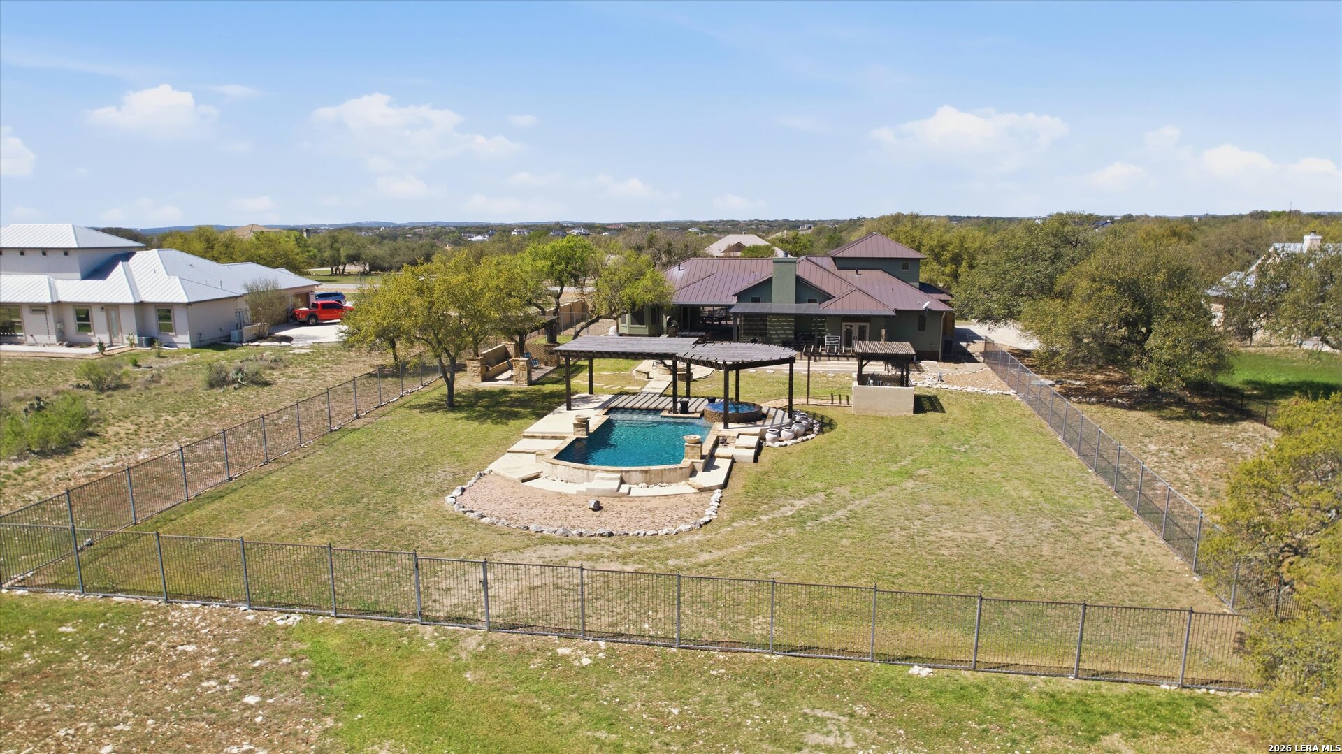 439 Mystic Parkway Spring Branch, TX 78070 - Photo 34 of 39 an aerial view of a house with swimming pool and mountains
