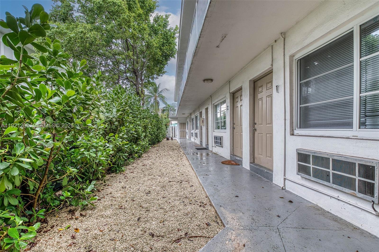 6921 Rue Vendome, Unit 1 Miami Beach, FL 33141 - Photo 15 of 27 a view of a pathway both side of house