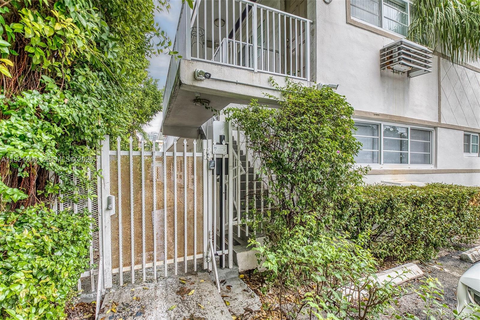 6921 Rue Vendome, Unit 1 Miami Beach, FL 33141 - Photo 16 of 27 a view of a house with a small yard and plants