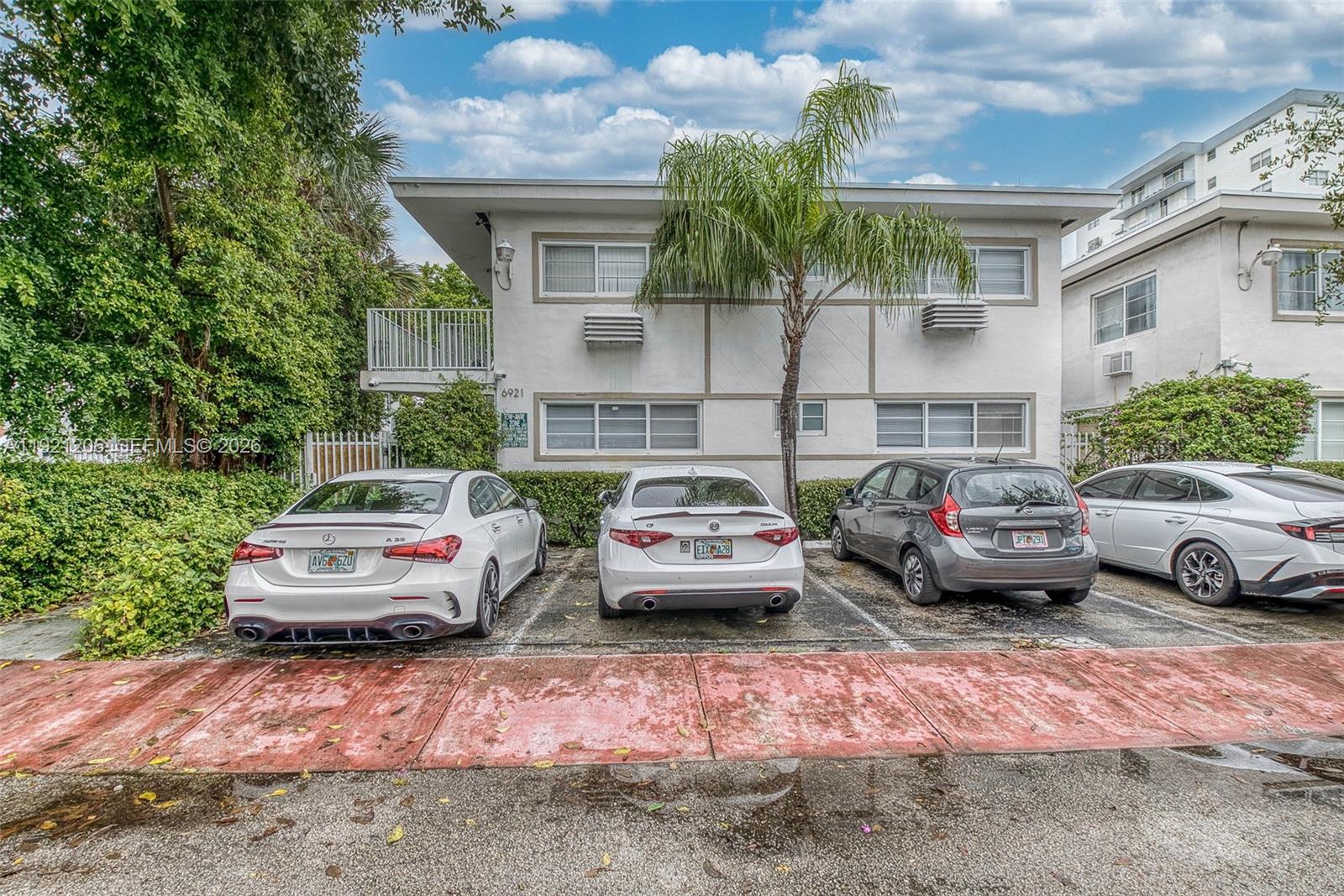 6921 Rue Vendome, Unit 1 Miami Beach, FL 33141 - Photo 17 of 27 a front view of a house with parking