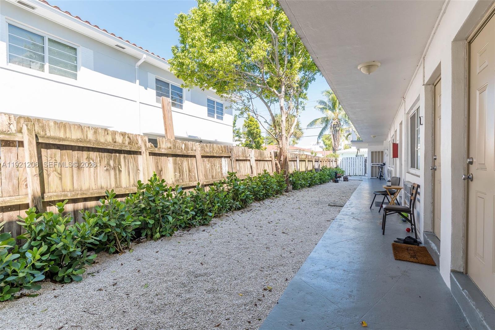 6921 Rue Vendome, Unit 1 Miami Beach, FL 33141 - Photo 21 of 27 a view of a pathway with a backyard