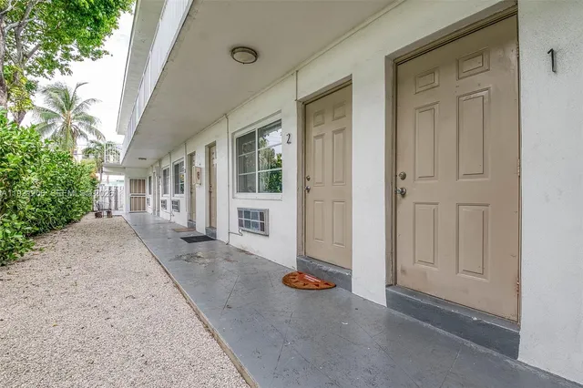 a view of a house with backyard and glass door