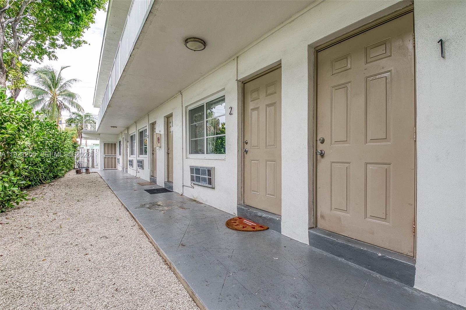 6921 Rue Vendome, Unit 1 Miami Beach, FL 33141 - Photo 23 of 27 a view of a house with backyard and glass door