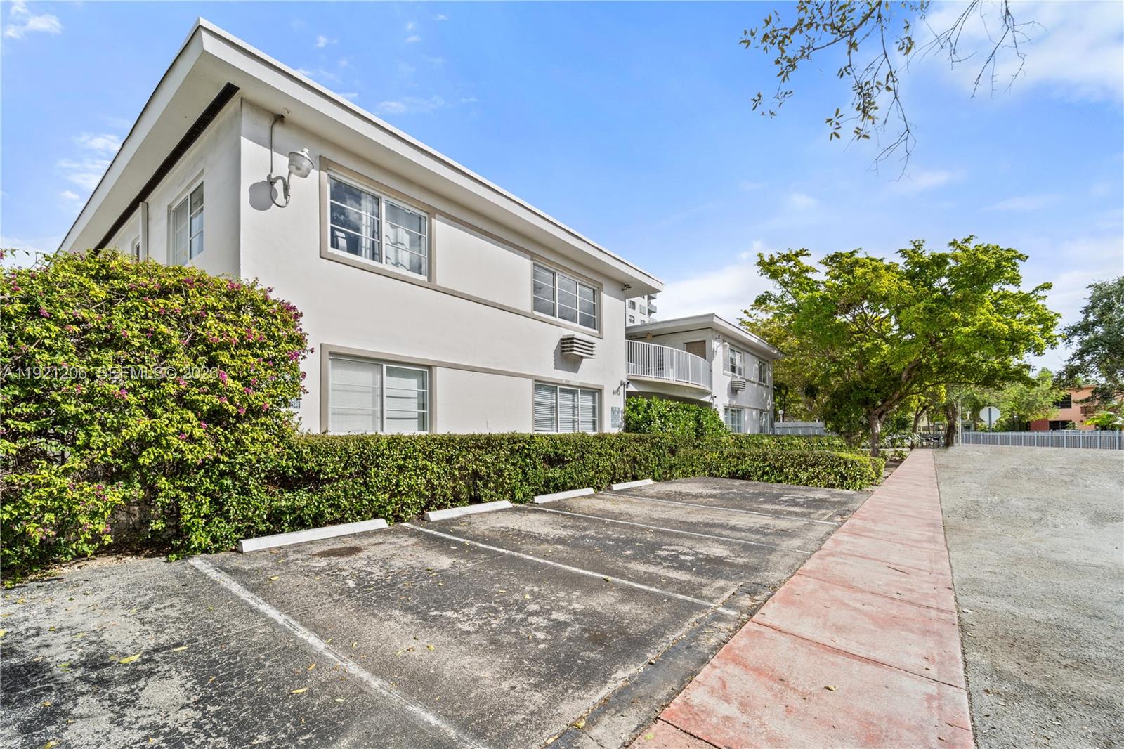 6921 Rue Vendome, Unit 1 Miami Beach, FL 33141 - Photo 27 of 27 a front view of a house with a yard and garage