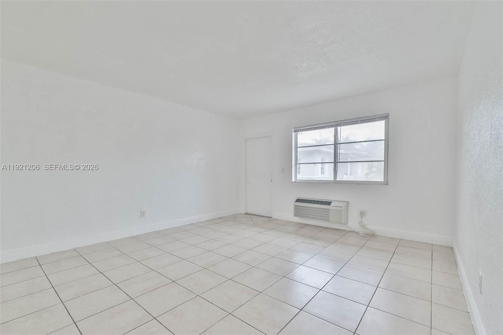 6921 Rue Vendome, Unit 1 Miami Beach, FL 33141 - Photo 4 of 27 an empty room with windows