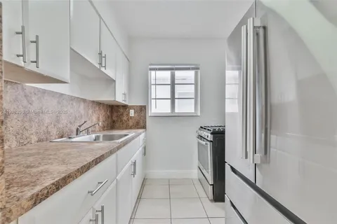 a kitchen with a refrigerator and a sink