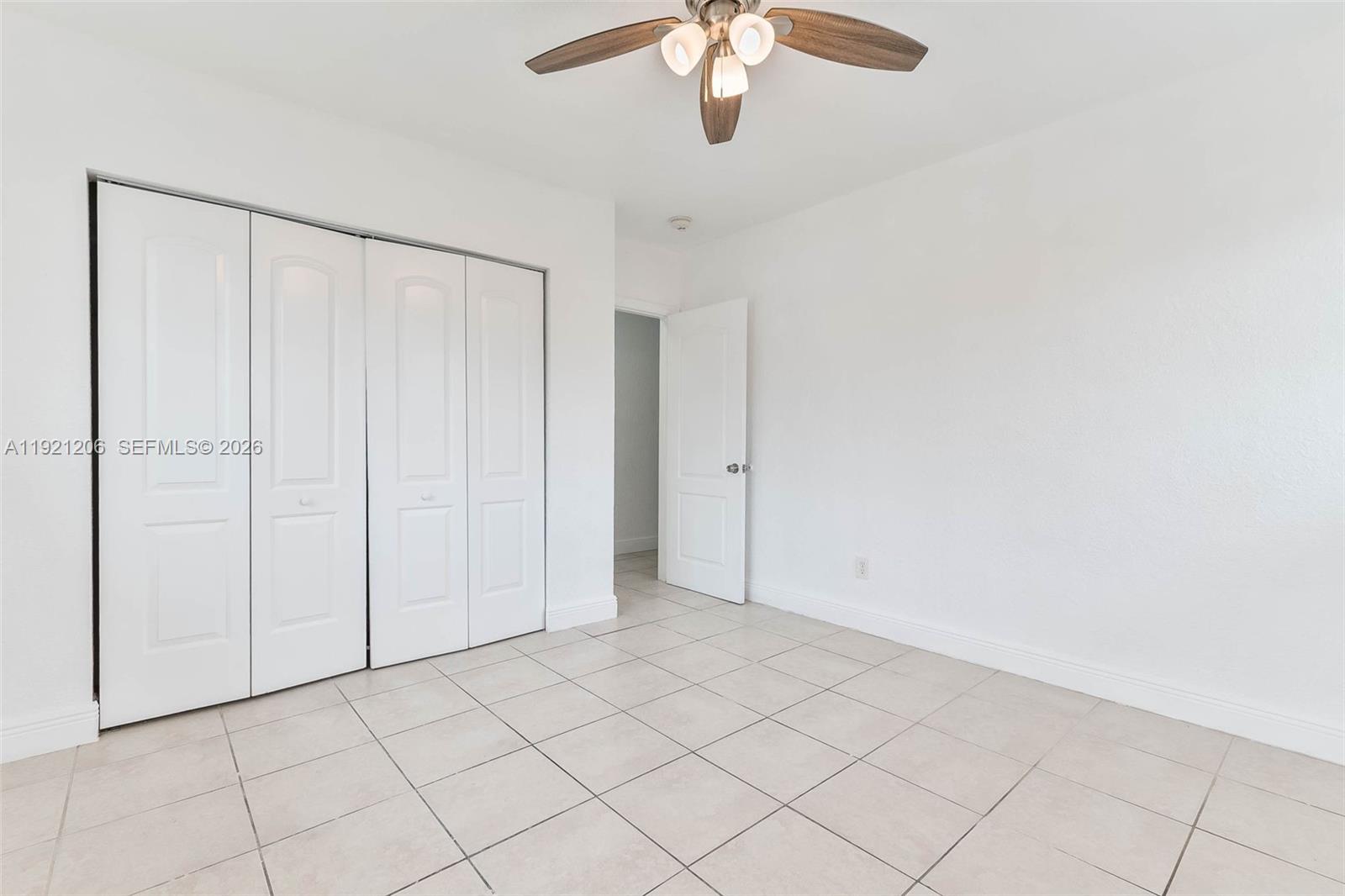 6921 Rue Vendome, Unit 1 Miami Beach, FL 33141 - Photo 9 of 27 an empty room with chandelier fan