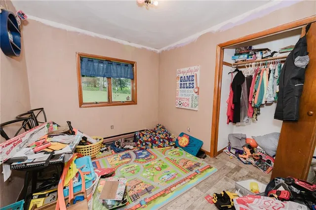 a bed room with a bed a closet and a mirror