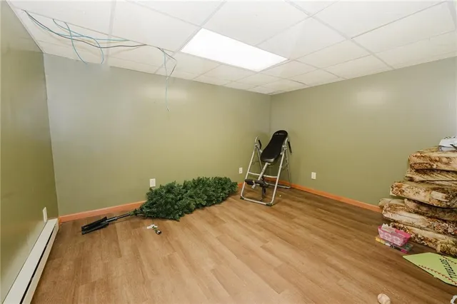 a view of a room with wooden floor and furniture