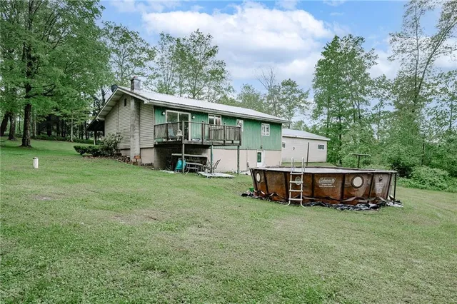 a view of a house with a yard and sitting area
