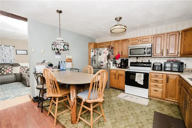 a kitchen with stainless steel appliances kitchen island granite countertop a stove a sink and a microwave