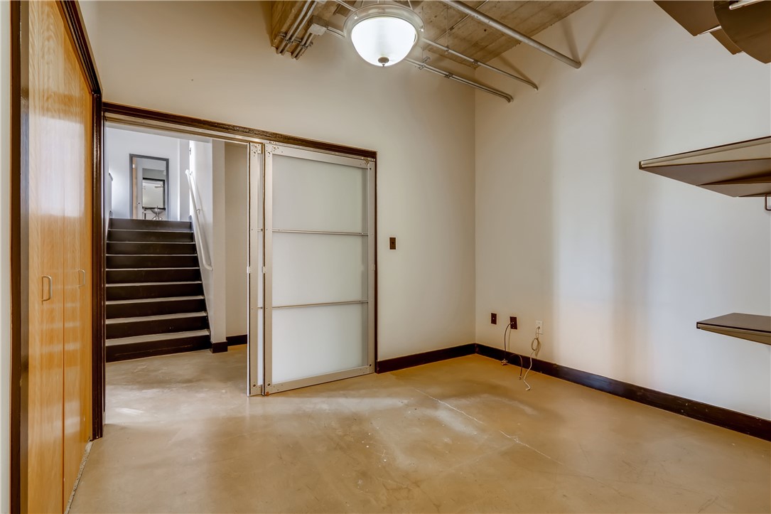 710 Colorado Street, Unit 4J Austin, TX 78701 - Photo 21 of 37 Downstairs bedroom features custom metal barn door