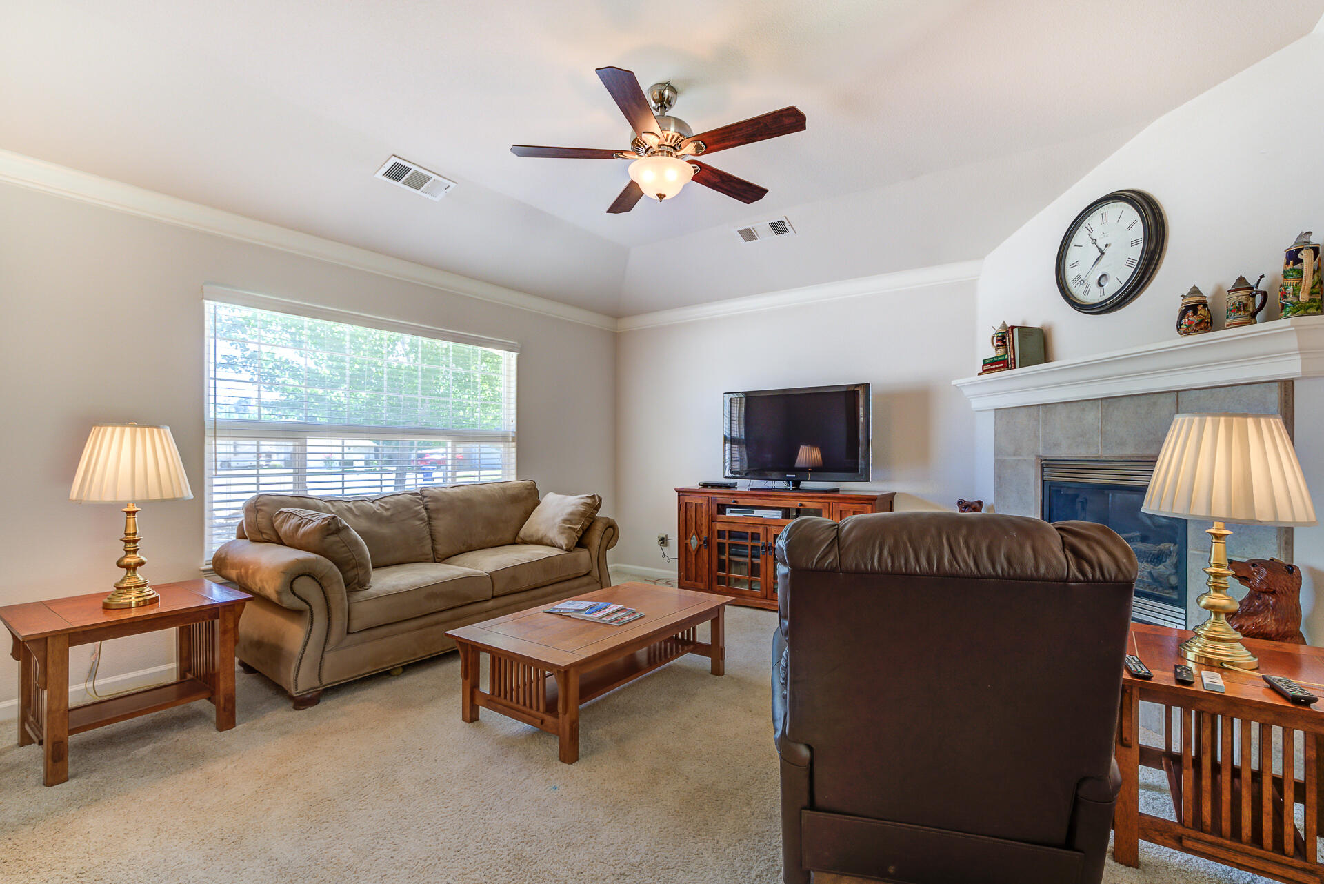 2697 Rhinestone Way Redding, CA 96001 - Photo 3 of 31 a living room with furniture a flat screen tv and a large window