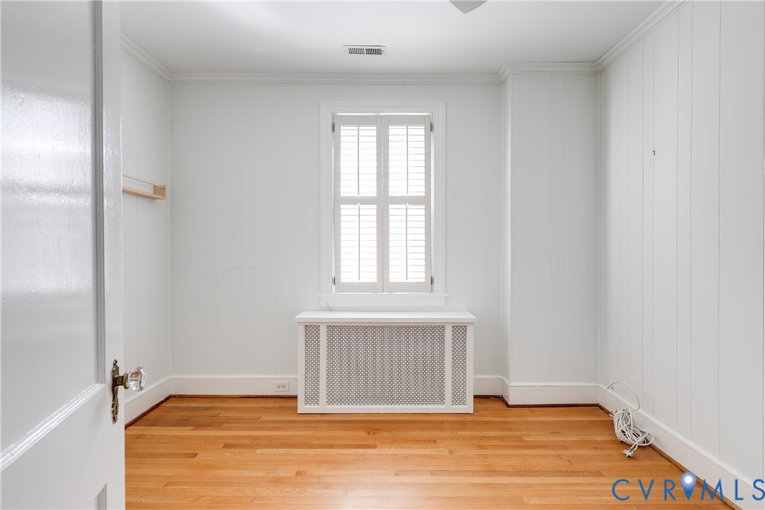 4617 Sylvan Road Richmond, VA 23225 - Photo 22 of 33 a view of an empty room with wooden floor and a window