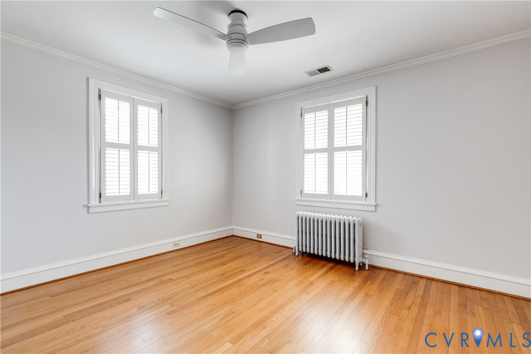4617 Sylvan Road Richmond, VA 23225 - Photo 25 of 33 a view of an empty room with wooden floor and a window