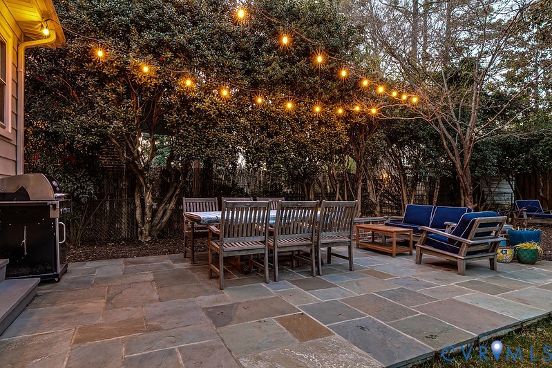 4617 Sylvan Road Richmond, VA 23225 - Photo 33 of 33 a view of a chairs and tables in the back yard of the house