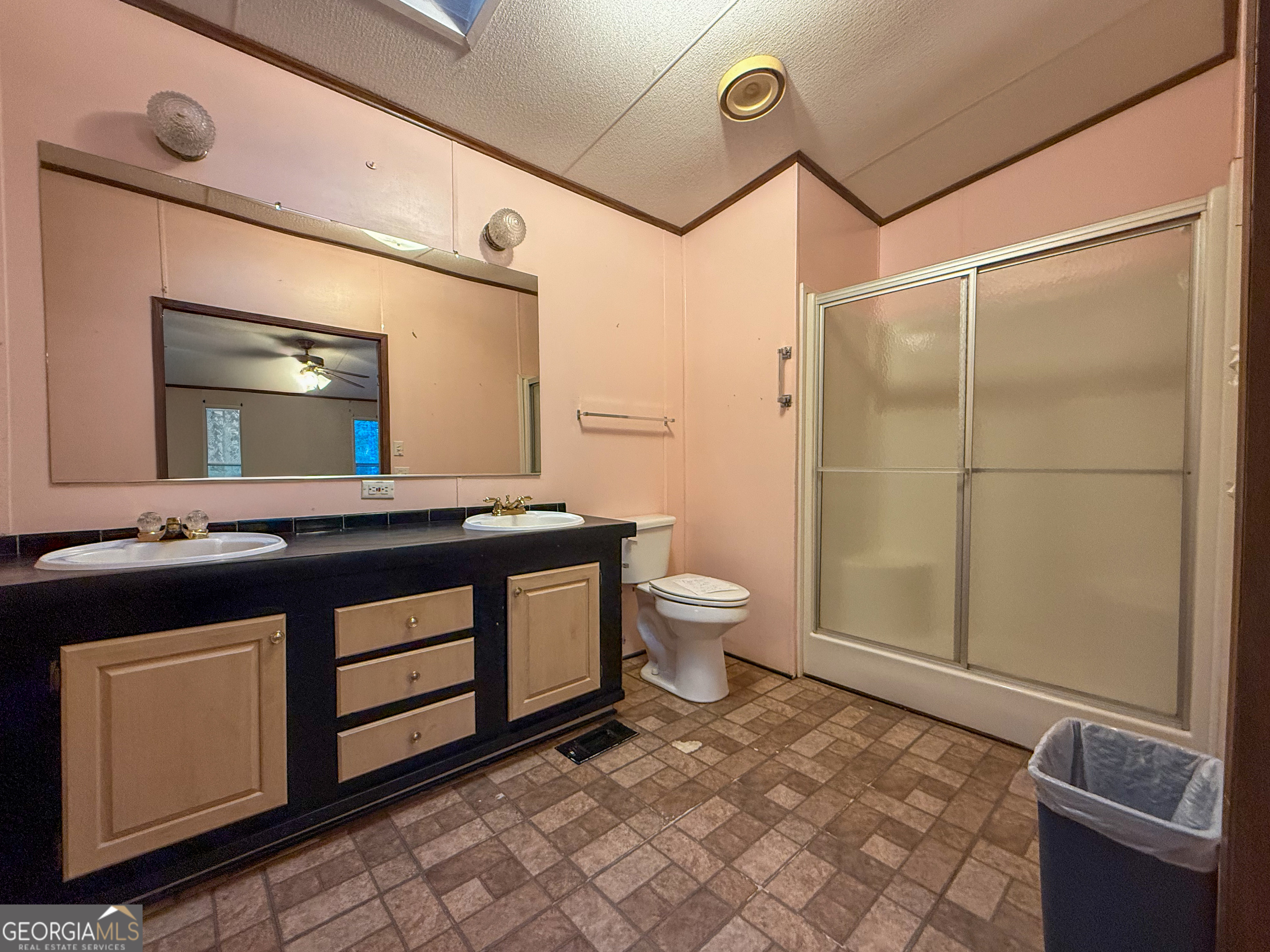 431 Paradise Valley Road Cleveland, GA 30528 - Photo 13 of 27 a spacious bathroom with a double vanity sink a toilet and a mirror