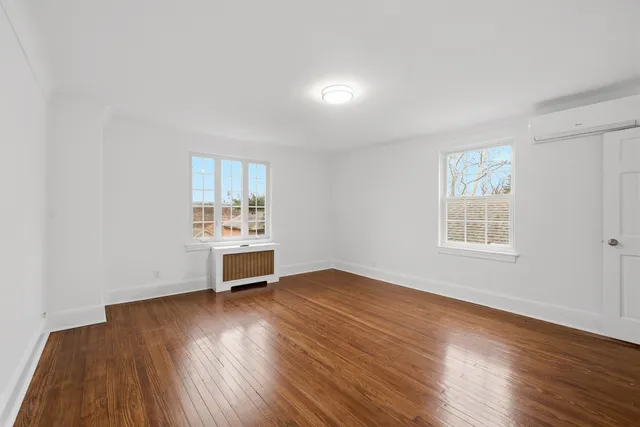a bedroom with a large bed and a fireplace