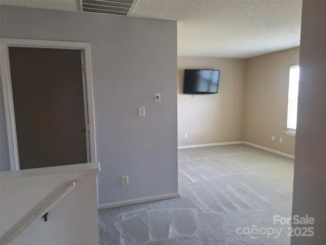 a view of a hallway with wooden shelves