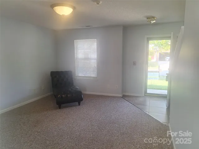 a view of an empty room and a window