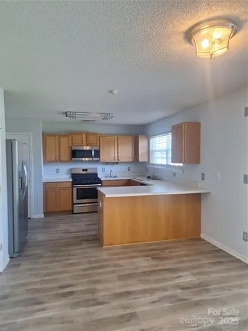 a view of kitchen with granite countertop cabinets and sink