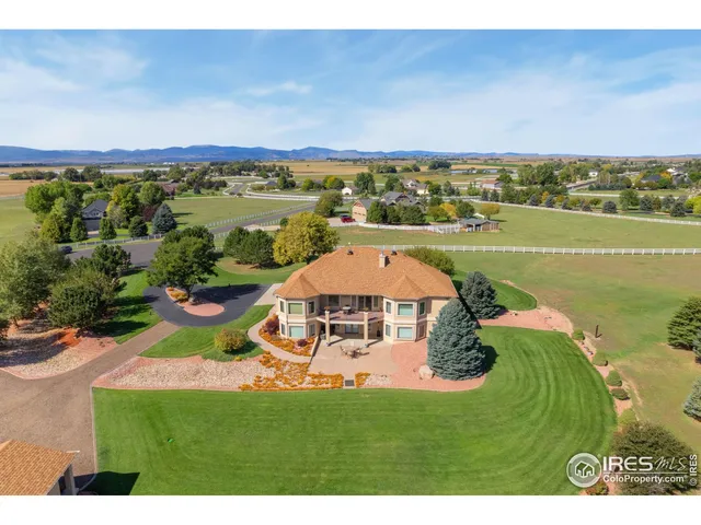 an aerial view of a house with a lake view