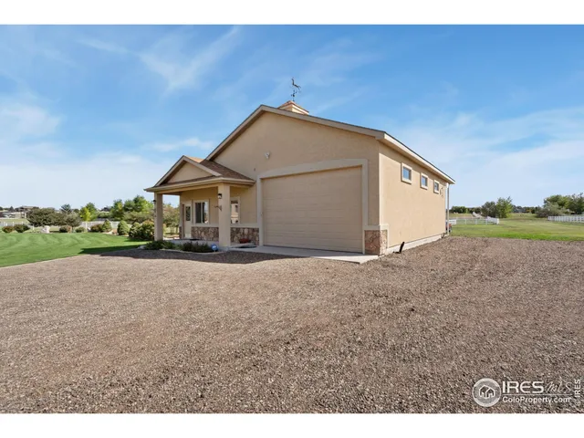 a view of a house with a yard and garage