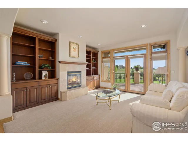 a living room with furniture large window and flat screen tv
