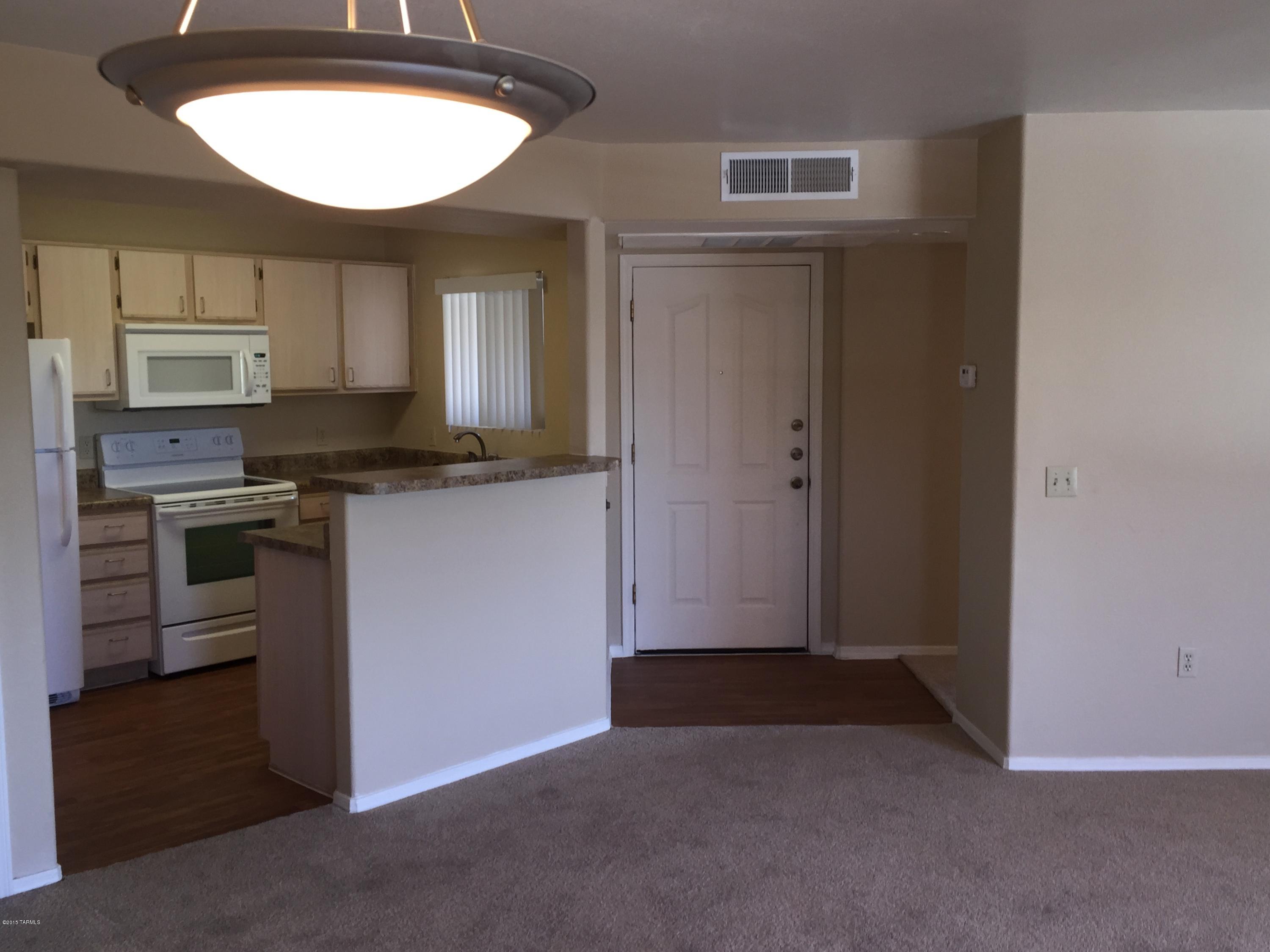 5751 North Kolb Road, Unit 28201 Tucson, AZ 85750 - Photo 2 of 14 an empty room with kitchen appliances and cabinets